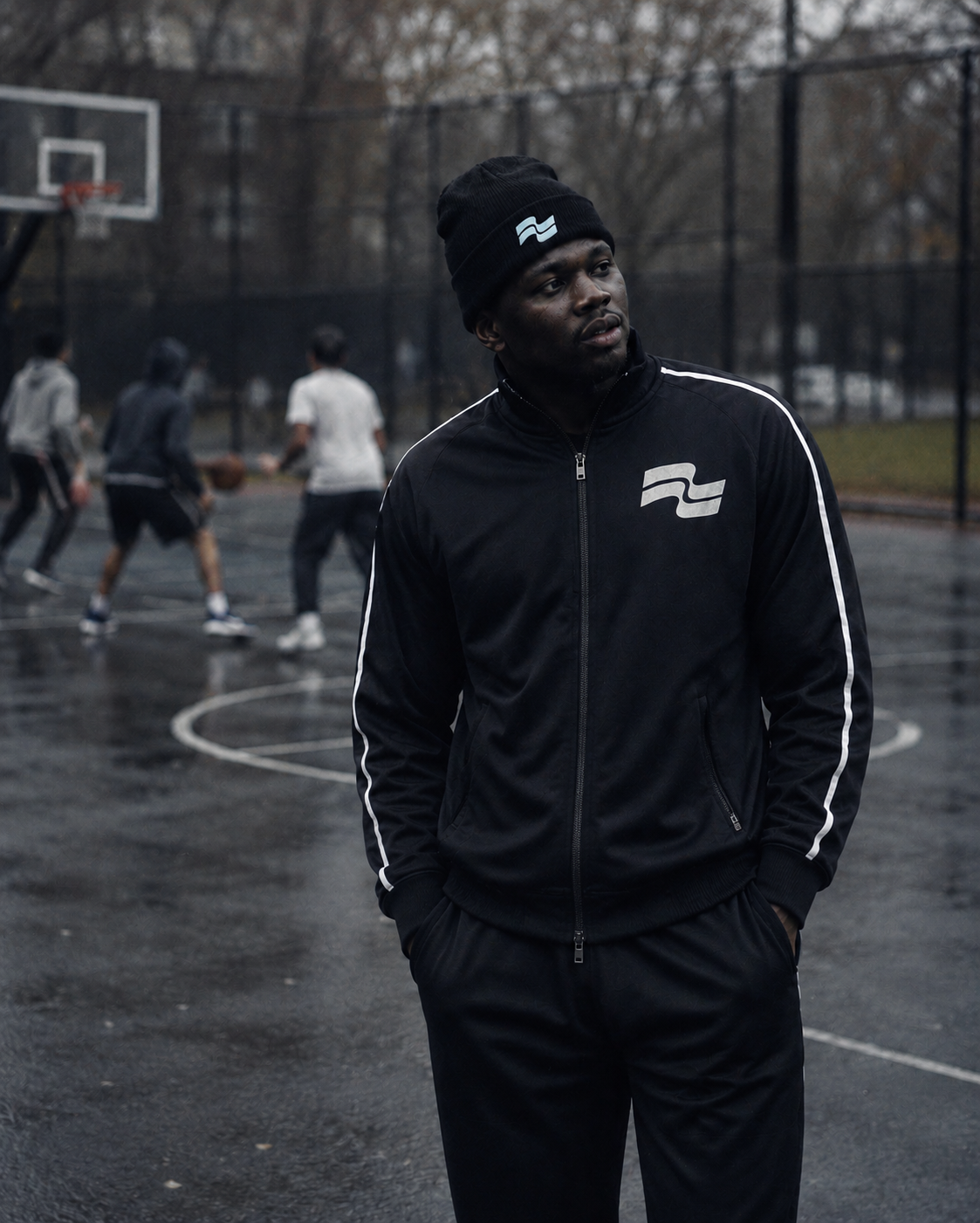 Black basketball jacket side view with white piping
